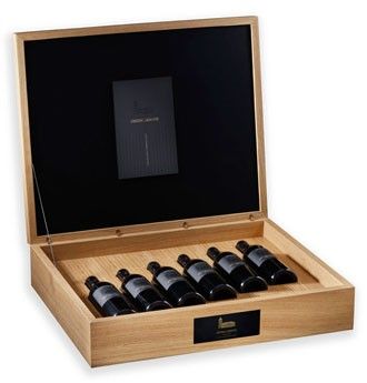 A bottle of Sauvignon Blanc paired with artisan bread and cheese on a wooden board.